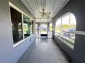 Enclosed sunroom featuring tiled flooring and ample natural light through large windows at 1405 Dorchester St, Port Charlotte, FL 33952