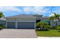 Two-story house with three-car garage and landscaped yard at 25133 Longmeadow Dr, Punta Gorda, FL 33955