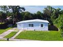 Light blue ranch home with a neat lawn and paved driveway at 8495 Cristobal Ave, North Port, FL 34287
