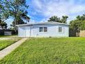A charming light blue ranch home with a well-maintained lawn at 8495 Cristobal Ave, North Port, FL 34287