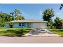 Newly built home with light blue exterior, two-car garage and well-maintained lawn at 20340 Zelda Ave, Port Charlotte, FL 33952
