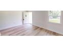 Bright living room featuring light wood-look flooring and an open floor plan at 20340 Zelda Ave, Port Charlotte, FL 33952