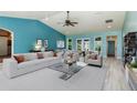 Spacious living room with vaulted ceilings and light-colored furniture at 8516 Riverside Dr, Punta Gorda, FL 33982