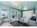 Primary bedroom with access to a patio and light teal walls at 8516 Riverside Dr, Punta Gorda, FL 33982