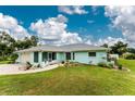 Charming single-story home with a well-manicured lawn and a welcoming, curved walkway leading to the front entrance at 7456 Jennifer Dr, Port Charlotte, FL 33981
