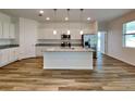 Modern kitchen with white cabinets, granite countertops, and a large island at 16216 Minorca Dr, Punta Gorda, FL 33955