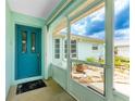 Enclosed porch with teal door leading into the house at 7456 Jennifer Dr, Port Charlotte, FL 33981