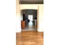 View through archway showing living room with hardwood floors and access to other rooms at 3404 Penelope Ter, North Port, FL 34286