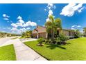 Tan twin villa with two-car garage and lush landscaping at 8883 Tuscany Isles Dr, Punta Gorda, FL 33950