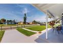 Neatly landscaped lawn with a view of a quiet residential street at 8724 Agress Ave, North Port, FL 34287