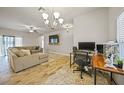 Open concept living room with sectional sofa and dedicated workspace at 725 Essex Ave, Port Charlotte, FL 33948