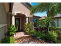 Inviting entryway with columns, lush landscaping and brick pavement at 13948 Miranese St, Venice, FL 34293