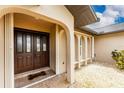 Double-door entry with a decorative glass insert and a covered porch at 1459 Blue Lake Cir, Punta Gorda, FL 33983