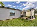 Cozy patio with pergola and seating area at 481 Ricold Ter, Port Charlotte, FL 33954