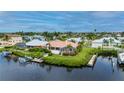 Aerial view of waterfront home with private dock and lush landscaping at 5480 Sea Edge Dr, Punta Gorda, FL 33950
