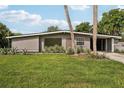 Charming mid-century home with a lush green lawn at 1642 Banyan Dr, Venice, FL 34293