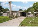 Updated mid-century home with driveway and landscaping at 1642 Banyan Dr, Venice, FL 34293
