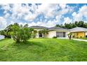 One-story house with a grassy yard, featuring a screened-in porch and palm trees at 3721 Monday Ter, North Port, FL 34286
