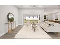 Bright and airy living room with a cozy seating area and large sliding doors leading to the backyard at 13493 Los Angeles Ave, Port Charlotte, FL 33981