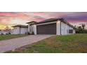 View of the home's side showcasing the garage and backyard at 13493 Los Angeles Ave, Port Charlotte, FL 33981