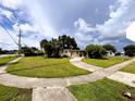 House with a large grassy yard and a long driveway at 21098 Glendale Ave, Port Charlotte, FL 33952