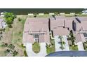 Aerial view of the house with a tile roof, screened in patio, and an attached two-car garage at 3800 Bal Harbor Blvd # 212, Punta Gorda, FL 33950