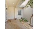 The front door is decorated with a security door, a potted plant, and rock landscaping at 3800 Bal Harbor Blvd # 212, Punta Gorda, FL 33950
