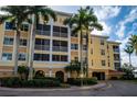 Three-story building with balconies and palm trees at 255 W End Dr # 3202, Punta Gorda, FL 33950