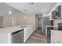 Modern kitchen with island, stainless steel appliances, and white cabinets at 1019 Cazenovia St, Port Charlotte, FL 33952