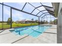 Relaxing screened-in pool area with a spacious deck, offering a tranquil backyard oasis at 17018 Alpenhorn Ct, Punta Gorda, FL 33955