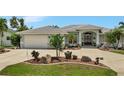 Single-story home with a two-car garage and nicely landscaped front yard at 3906 Crooked Island Dr, Punta Gorda, FL 33950