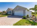 Charming home with a paved driveway, two-car garage, and well-maintained landscaping at 27261 Guapore Dr, Punta Gorda, FL 33983