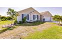 Single Gathering home featuring decorative shutters, palm trees, and fresh landscaping at 27261 Guapore Dr, Punta Gorda, FL 33983