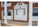 Brick building with white columns and entrance at 4158 Tamiami Trl # U6, Port Charlotte, FL 33952