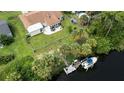 An aerial view of a home with a private boat dock and access to a waterway at 2256 Auburn Blvd, Port Charlotte, FL 33948
