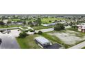 Aerial view showing home's location near canal and golf course at 108 Boundary Blvd # A&B, Rotonda West, FL 33947