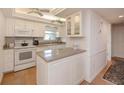 Bright kitchen with white cabinets and granite countertops at 3251 White Ibis Ct # C4, Punta Gorda, FL 33950