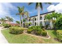 Two-story home with double doors and palm trees at 28 Colony Point Dr, Punta Gorda, FL 33950