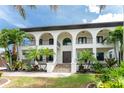 Two-story home with double doors and palm trees at 28 Colony Point Dr, Punta Gorda, FL 33950