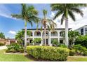 Two-story home with double doors and palm trees at 28 Colony Point Dr, Punta Gorda, FL 33950