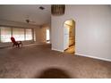 Spacious living room with carpeted floors and a view of the kitchen at 1565 Dorchester St, Port Charlotte, FL 33952