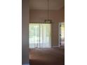 Simple dining room with carpet flooring and access to a patio or deck at 1565 Dorchester St, Port Charlotte, FL 33952