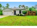 Newly built home with a two-car garage and landscaped lawn at 27096 Tribune Blvd, Punta Gorda, FL 33955