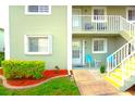 Condo entryway with stairs, landscaping, and seating area at 3310 Loveland Blvd # 2301, Punta Gorda, FL 33980