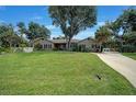 One-story house with landscaping and driveway at 182 Monica St, Port Charlotte, FL 33954