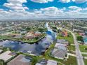 Aerial view of waterfront home with private pool and canal access at 855 Pamela Dr, Punta Gorda, FL 33950