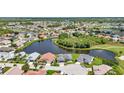 Aerial view of homes and lake in Del Webb community at 1708 Palace Ct, Punta Gorda, FL 33980