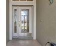 Front door with glass inserts and sidelight at 1708 Palace Ct, Punta Gorda, FL 33980