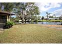 Backyard with a screened patio overlooking a tranquil pond at 3568 Middletown St, Port Charlotte, FL 33952