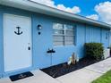 Charming light blue home with a well-maintained lawn and walkway at 820 Kings Ct # D, Punta Gorda, FL 33950